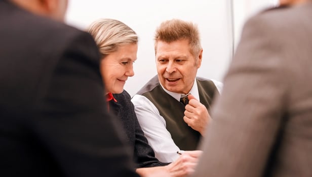 Business people smiling and connecting at a meeting