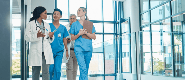 doctor-walks-with-team-through-hospital-while-talking-about-prosci-change-management