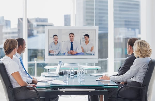 Business team having video conference with another business team in office