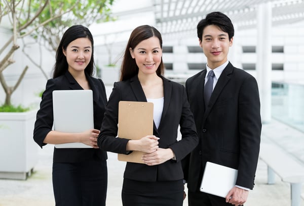 Confident business people hold with clipboard and digital device