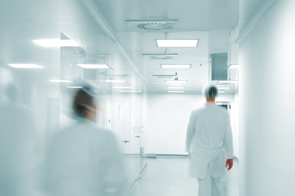Working people with white uniforms walking in modern  factory environment