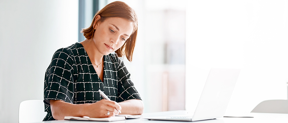 Woman writing in a note book