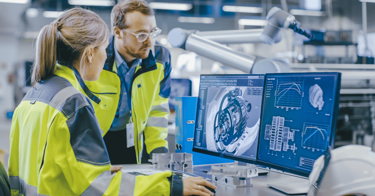 Engineers analyzing CAD models and data charts as part of digital transformation in manufacturing